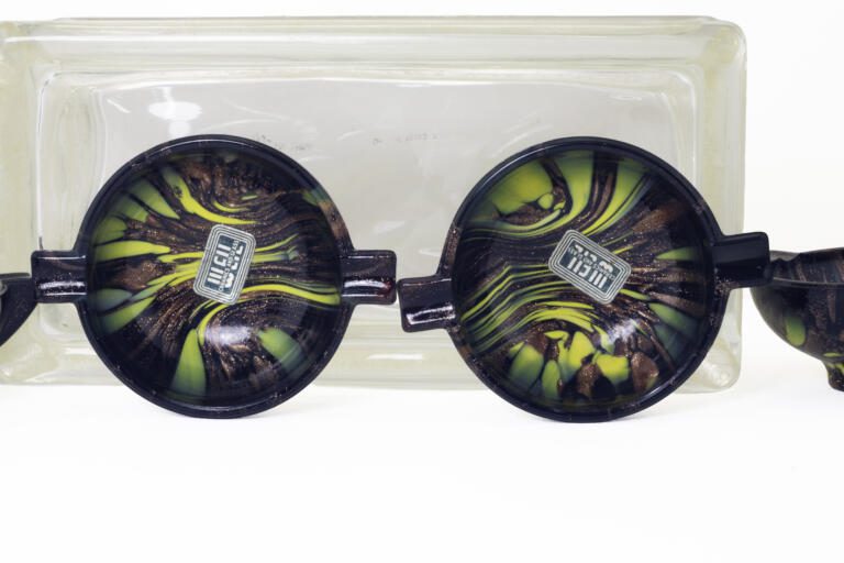 Set of four unused Venetian glass ashtrays with aventurine and monochrome décor in ebony black glass. Three ashtrays still retain the original Weil sticker. All unused.